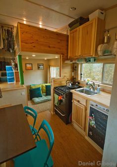 a kitchen and living room in a tiny home