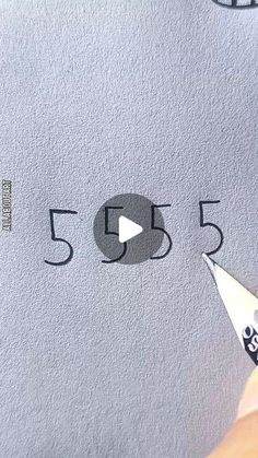 someone is drawing the numbers on a piece of paper