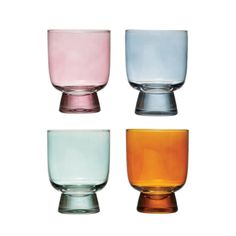 four different colored glass cups sitting next to each other