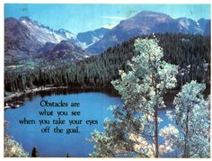 a lake surrounded by mountains and trees with a quote written on the side that says obstacles are what you see when you take your eyes off the goal