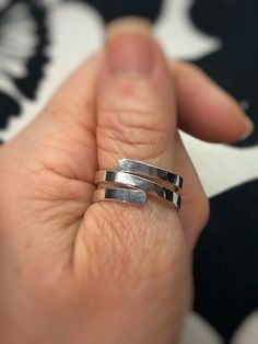 "This ring is made with a thick gauge Fine Silver wire that has been hammered and shaped into a stylish, modern design perfect for everyday wear! Fine Silver is 99.9% pure silver vs. Sterling Silver which is 92.5% pure silver and 7.5% copper. Fine silver will not tarnish as quickly as sterling but to keep it's shine, a jewelry polishing cloth is all that's needed.  ❤️ MATERIALS USED      ▪️Fine Silver wire ❤️ MEASUREMENTS      ▪️The back of the ring is approximately 5/16\" wide and the front is 3/8\" ❤️ SIZE      ▪️Ring size 9 ❤️ PROCESSING TIME      ▪️The item will be processed and shipped within 1-3 business days from the                   time the order is placed and payment is received. ❤️ SHIPPING/PACKAGING      ▪️This item will be shipped USPS first class to the USA.       ▪️If you w Adjustable Rings With A Modern Twist For Promise, Hand Forged Open Band Ring As Gift, Adjustable Promise Ring With A Modern Twist, Modern Twist Adjustable Promise Ring, Modern Adjustable Stackable Promise Rings, Adjustable Hammered Jewelry For Promise, Modern Hand Forged Stackable Rings For Anniversary, Modern Adjustable Hand Forged Rings, Hammered Thick Band Ring As Gift