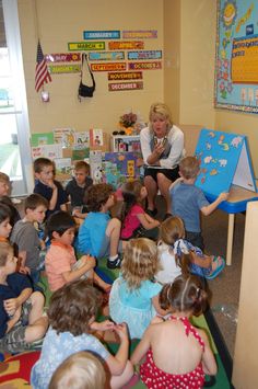 a woman reading to children in a classroom