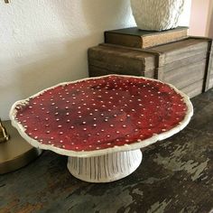 a cake plate sitting on top of a wooden table