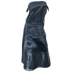 Chic minimalist at its best! This 1990s JIL SANDER strapless dress is so much more than a classic little black dress. You will find yourself wondering if you are wearing a black or gunmetal dress. Beautiful metallic 'wet look' fabric gives off the perfect sheen. Adjustable straps at each side of the bodice to ensure proper fit. Hidden zipper up the back with hook-and-eye closure. A very flattering fit that can easily transition from day to evening, and is perfect for layering. In great unworn co Chic Black Strapless Dress For Black-tie Events, Black Silk Strapless Cocktail Dress, Black Silk Strapless Evening Dress, Black Silk Strapless Dress For Evening, Jil Sander 90s, Silk Charmeuse Dress, Chic Minimalista, Classic Little Black Dress, 1990s Dress