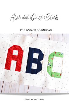 an applique quilt block with the letters abc and q in red, green, blue, and white