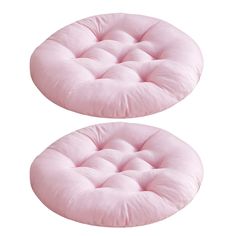 two pink round cushions sitting on top of each other