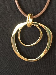 "The mattie gold tone metal two circle eyeglass necklace. An easy, pretty way to keep your eyewear close at hand and safe. Looks great as just a necklace also:) The hypoallergenic cotton cord is about 27\" long with a gold tone lobster clasp. The gold tone metal component is about 2 1/4\" in length and 1 3/4\" wide. If you would like another length cord, just specify the length preferred at checkout and I would love to make it for you! Thanks, Benita" Trendy Adjustable Gold Necklace, Gold Metal Necklace With Adjustable Length, Modern Gold Jewelry With Adjustable Length, Trendy Gold Circular Necklace, Trendy Gold Circle Necklace, Adjustable Gold-tone Round Necklaces, Adjustable Gold Metal Necklace, Elegant Metal Jewelry With Adjustable Cord, Elegant Metal Necklace With Adjustable Cord