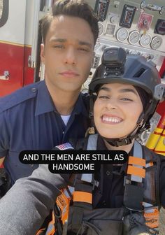 a man and woman are posing in front of a fire truck