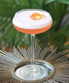 a cocktail with an orange garnish on the rim