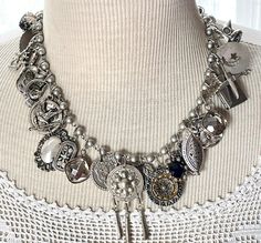 From a once loved, large collection of vintage jewelry, including necklaces, bracelets and earrings, I have gleaned all these silvery components to create a stunning assemblage necklace.    This is a fully loaded collection of interesting components that have a lovely weight and sound.  The silvery-gray pearlized glass bead chain is 18" long. I work with vintage and antique parts. Some may show some signs of wear or age. Please look at the pictures carefully, and contact me before purchasing if you have any questions. I can send additional pictures if you prefer. I like to think that older items possess a character that newer items have not yet earned. Vintage Button Necklace, Vintage Assemblage Jewelry, Assemblage Necklace, Button Necklace, Choker Jewelry, Assemblage Jewelry, Charm Necklaces, Jewelry Statement, Antique Buttons