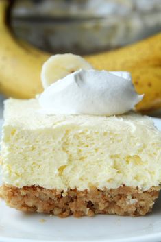 a piece of cheesecake on a plate with a banana in the background