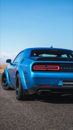 the rear end of a blue sports car