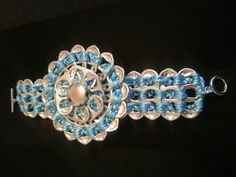 a blue and white beaded bracelet on a black background