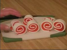 a person is cutting up some candy rolls