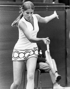 a woman swinging a tennis racquet at a ball