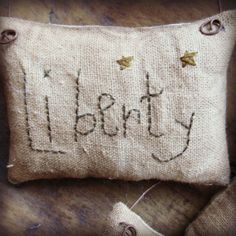 a pillow with the word party written on it and two gold stars hanging from the back