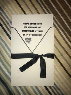 a birthday card with a black ribbon tied around it