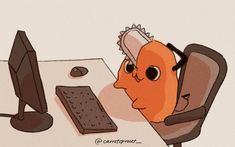 an orange bird sitting at a computer desk