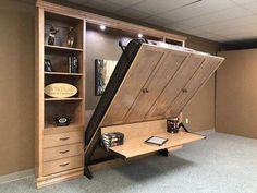 a room with a desk and bookcase that has an upside down shelf on it