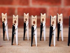 several pairs of scissors shaped like cats with eyes and noses on them, sitting next to each other