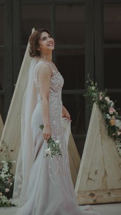 a woman in a wedding dress is smiling