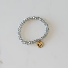 Add some bling to your wrist with our Personalized Crystal Stacks! You can personalize your stack bracelet with a name, date, initials, or a word of choice on a simple, classic disc charm. With neutral colors and faceted beads that shine and shimmer in the light, you can be reminded of a motivating word, memory, or special loved one whenever you look down at your wrist! A perfect gift for the everyday stack wearing lover! *Elastic stack bracelets are made with 6mm faceted crystals *Personalized Adjustable Nickel-free Name Bracelet For Everyday, Silver Stackable Charm Bracelet For Everyday, Silver Hypoallergenic Stretch Bracelet For Everyday, Personalized Adjustable Crystal Bracelet, Adjustable Personalized Crystal Bracelet, Nickel-free Silver Stretch Bracelet For Friendship, Everyday Silver Charm Bracelet With Custom Name, Personalized Silver Beaded Bracelets For Everyday, Everyday Stackable Round Name Bracelet