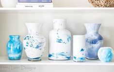 several vases are sitting on a shelf