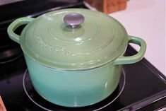 a green pot sitting on top of a stove