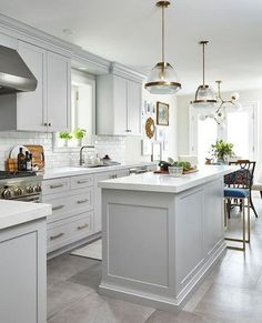 a kitchen with white cabinets and an island