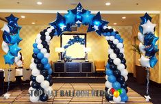 an arch decorated with blue and white balloons