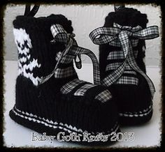 a pair of black and white knitted baby boots