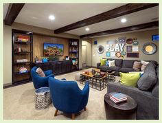 a living room with couches, chairs and a flat screen tv on the wall