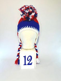 #1 LET'S GO BUFFALO!  Looking to level up your tailgating swag??? This is a one of a kind handmade (crochet) Buffalo football mohawk winter hat! It is made with doubled thick yarn to keep you warm from the pregame tailgate through the post-game VICTORY party! These hats are super cozy to protect you from the whipping winds and cold temps all football season.  Each hat is slightly different because they are all handmade. Each hat is made close to 22 inches in diameter around the largest part of my forehead. The band is crocheted to have some give to it, like elastic to allow each hat to fit multiple head sizes.    Please note these are custom made and I only have the number listed in stock. Crochet Buffalo, Buffalo Football, Crochet Unique, Thick Yarn, Football Season, Handmade Crochet, Victorious, Caps Hats, Buffalo