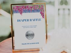 there is a sign that says diaper raffle on the table next to it