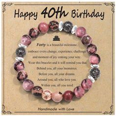 a happy birthday card with a bracelet made out of pink marbles and silver beads