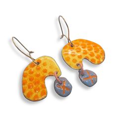 You'll feel gorgeous wearing these distinctive enamel polka dot earrings.  These statement earrings are lightweight, and are a standout mix of yellow, with orange polka dots, and a quirky light blue drop with a carved X.  They have high quality brass ear wires that clasp so you never have to worry about losing them!   What is enamel?   Enamel is made by fusing multiple layers of glass to a prepared metal at a very high heat.  Each earring requires between four to 10 layers of enamel depending on Orange Enamel Earrings For Gifts, Orange Enamel Earrings For Gift, Orange Enamel Earrings As A Gift, Hand Painted Yellow Enamel Earrings, Playful Enamel Earrings Nickel Free, Playful Enamel Nickel Free Earrings, Playful Enamel Nickel-free Earrings, Artistic Enamel Dangle Earrings, Playful Handmade Enamel Jewelry