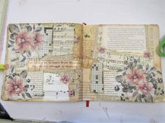 an open book with some flowers on it