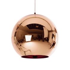 a large shiny metal ball hanging from a ceiling fixture with one light on the side