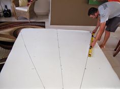 a man is measuring the length of a mattress