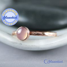 This Copper Rose Quartz Ring features a 6 mm cabochon that has been securely set in a highly polished fine copper bezel. The band is made of a sturdy round Copper wire that has been given a hammer texture, then carefully finished for comfortable wear. Our setting process involves carefully tightening the bezel around the stone, creating a water-tight seal with no stone movement. These beautiful rings make unique promise rings, lovely stacking rings, great birthstone rings, or just a wonderful lo Handmade Rose Gold Moonstone Ring For Anniversary, Rose Gold Stackable Rings With Bezel Setting For Gift, Rose Gold Moonstone Ring With Birthstone, Rose Gold Moonstone Birthstone Ring, Stackable Rose Gold Moonstone Ring, Stackable Round Moonstone Ring In Rose Gold, Rose Gold Gemstone Stackable Rings, Pink Quartz Ring, Pink Gemstone Ring