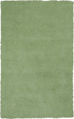 a green rug with small dots on it