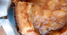 a close up of a pie in a pan with a spoon on the plate next to it