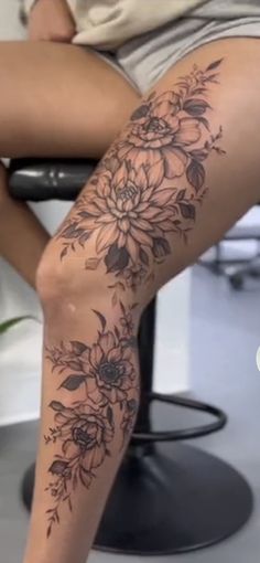 a woman's leg with flowers on it