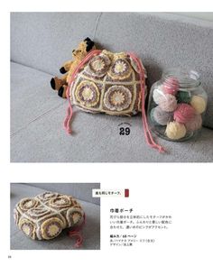 an image of a small purse on the ground with yarns in it and another bag next to it