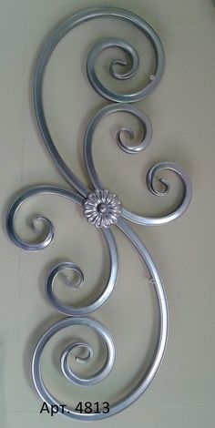 a metal wall decoration with swirls on it