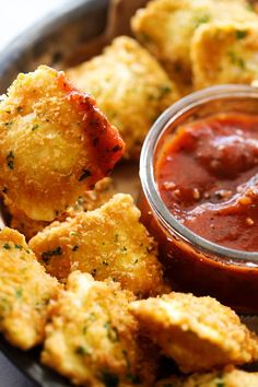 some fried food is on a plate with dipping sauce