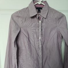 Tommy Hilfiger Ruffled Placket Striped Button Up Fitted Purple Shirt Blouse Size 2. Lightweight 100% Cotton Purple And White Striped Fabric. Collared Neck. Ruffle Detail Along Button Closure. Contrasting Velvet Ribbon Under Buttons. Fitted Button Down Shirt. Long Cuffed Sleeves. Rounded Hemline. See Photos For Measurements. New With Tags. Comes From Clean Pet And Smoke Free Home. Tommy Hilfiger Long Sleeve Blouse, Preppy Buttoned Tops For Work, Tommy Hilfiger Long Sleeve Blouse For Spring, Preppy Fitted Button-up Blouse, Fitted Button-up Preppy Blouse, Formal Ruffled Button-up Shirt, Tommy Hilfiger Spring Blouse For Work, Tommy Hilfiger Long Sleeve Work Shirt, Tommy Hilfiger Blouse For Spring Workwear