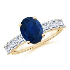 a yellow gold ring with an oval blue sapphire surrounded by baguettes and diamonds