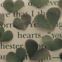 some green leaves are laying on top of an open book with the words love that i have