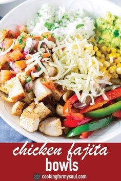 chicken fajita bowls with shredded cheese and vegetables in a white bowl on a blue table